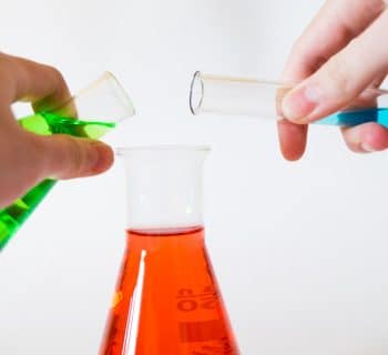 person holding laboratory flasks
