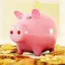 pink pig coin bank on brown wooden table