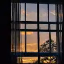 photo of blue framed glass window with curtain