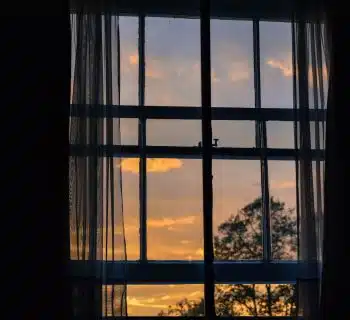 photo of blue framed glass window with curtain