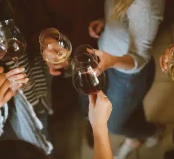 group of people tossing wine glass