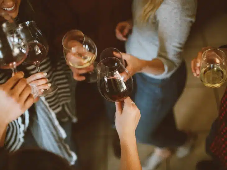 group of people tossing wine glass